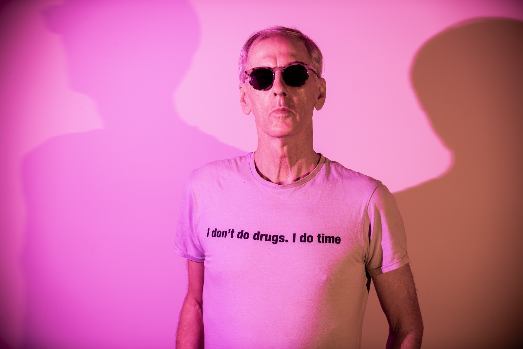A photograph of Robert Forster in t-shirt and sunglasses